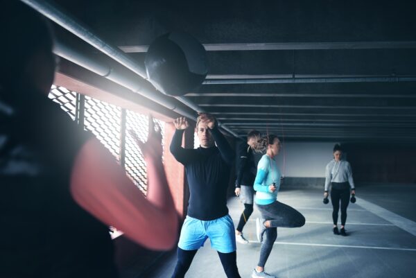 Group of people exercising together with medicine ball and skipping rope
